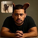 A charming French Bulldog lies on a beige carpet in front of a closed white door, looking up with big, soulful eyes and ears perked up, ready for some fun or a treat.