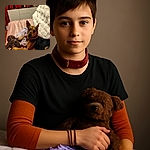 A charming dog lounges on a soft pink blanket, clutching a well-loved brown stuffed toy with a look that says 'Hey, this is mine!' The cozy room with red walls and quirky black figurines adds a warm, whimsical vibe to this candid snapshot.