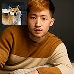 A relaxed Shiba Inu dog lounges comfortably on a fluffy white rug against a dark couch backdrop, gazing calmly at the camera with a serene expression.