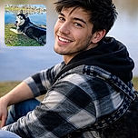 A happy husky lounges on the grassy bank by a serene lake filled with floating ducks, sporting a cool harness and leash, with a bright blue sky and bare trees in the background, capturing a perfect outdoor chill moment.