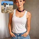 A curious little dog stands proudly on a sandy beach with the ocean and blue sky in the background, looking like the king of the dunes ready for its next adventure.