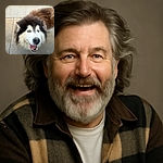 A fluffy dog with a mix of black, white, and brown fur looks up happily with its tongue out, standing on a concrete sidewalk with grass in the background. The dog's joyful expression and bright eyes make it a heartwarming candid moment.