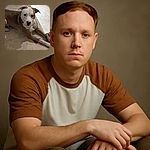 A thoughtful dog with a white and brown coat lounges on a tiled floor, paws stretched out over a colorful rope toy, gazing up with soulful eyes as if pondering the mysteries of fetch.