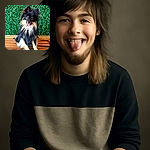 A fluffy black and tan Pomeranian dog sits happily on a wooden bench with its tongue playfully sticking out, posing against a vibrant green leafy background.