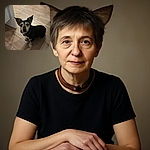 A small dog with large, attentive ears and soulful eyes looks up curiously from a wooden floor, surrounded by everyday home objects, capturing a candid moment of canine curiosity.