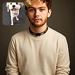 A fluffy cream-colored dog with a slightly blurred wagging tail looks up with big, curious eyes on a textured pavement background, capturing a moment of playful anticipation.