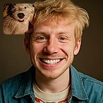 A close-up of a scruffy white dog showing off its teeth in what looks like a goofy smile, with a colorful patterned background and a warm indoor lighting vibe.