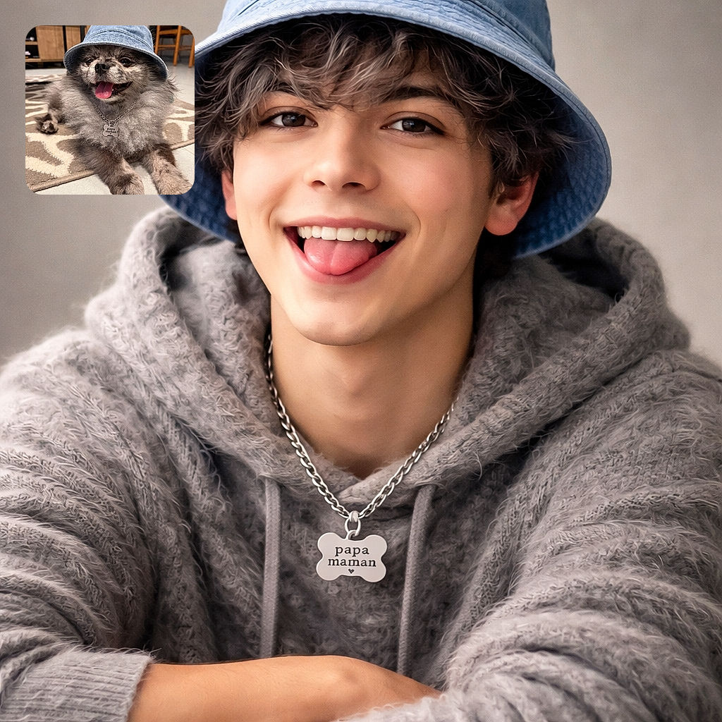 A fluffy dog sporting a cool denim bucket hat and a chain necklace with a bone-shaped tag that reads 'papa maman' lounges happily on a patterned rug, tongue out and clearly enjoying the spotlight indoors.