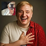 A joyful light-colored dog is being hugged tightly by a person in a red patterned outfit, both sharing a cozy moment on a couch with a pillow in the background. The dog's happy face and open mouth make it look like it's smiling for the camera.
