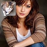 A tabby cat with striking green eyes lounges on a textured surface, gazing intently as if plotting its next stealthy move. The natural light highlights the cat's fur patterns and white paws, creating a cozy yet alert vibe.
