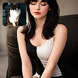 A black and white cat sits peacefully on a cushioned outdoor chair, basking in the warm sunlight with eyes closed as if meditating on the meaning of life.