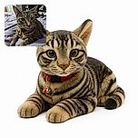 A tabby cat lounges on a rumpled lavender bedspread, staring into the camera with the intense focus of a tiny furry detective. Its enormous ears, bright eyes, whiskers, and colorful collar steal the show while shelves and bedroom furniture create a cozy backdrop.