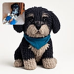 A fluffy black and white dog lies on a carpeted floor next to a blue plush toy shaped like a bear with rope limbs, looking attentively at the camera with bright eyes under soft indoor lighting.