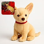 A small tan dog, possibly a Chihuahua, is lounging comfortably on a pile of colorful and cozy blankets, with a curious look on its face as if wondering about the next adventure or snack.