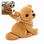 A tiny tan dog gives the camera an impressively suspicious side-eye, as if it has just discovered the household's most scandalous secret. Its glossy eye, fuzzy ears, and oversized nose dominate this cozy close-up against a softly blurred background.