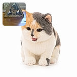 A chatty calico cat sits inside a tiny patterned cardboard fort, looking like the proud commander of Meowgical Camelot while the hardwood floor reflects its royal headquarters.