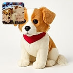 A cozy little dog with white and brown fur is curled up on a soft, fluffy pink blanket atop a leopard-print couch, gazing with soulful eyes that say 'nap time or snack time?'