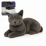 A dignified gray cat lounges across a fluffy blanket, staring into the camera like it has just been promoted to head of household. A giant purple teddy bear stands guard in the background while the bedding creates a cozy bedroom throne.