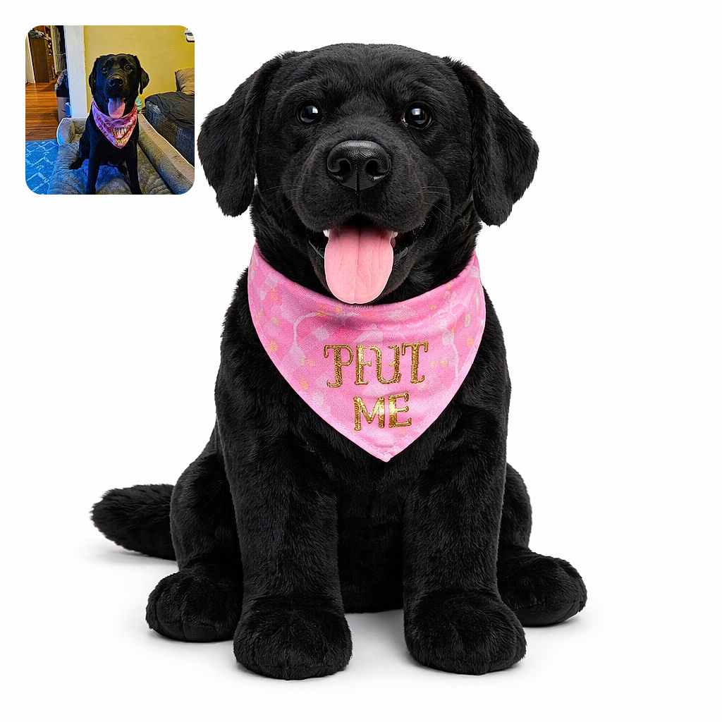 A happy black dog sits proudly on a cozy gray pet bed wearing a pink bandana that says 'Hug Me', tongue out and eyes bright, surrounded by a warm indoor setting with wooden floors and comfy furniture.