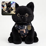 A curious black cat dressed in a quirky patterned outfit lounges on a couch surrounded by colorful bags and a plastic bag, looking intently upwards as if pondering the mysteries of the universe or just waiting for a treat.