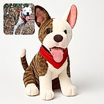 A happy, excited dog with a red bandana is standing outdoors on a leafy ground, tongue out and ears perked up, looking ready for an adventure in the woods.