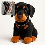 A majestic Doberman sits patiently, bathed in sunlight that highlights its shiny black and tan coat, with a silver chain collar adding a touch of elegance to this noble canine portrait.