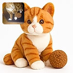 A slightly blurry photo of an orange tabby cat with white paws lounging on a dark surface next to a textured ball, with an orange background adding warmth to the scene.