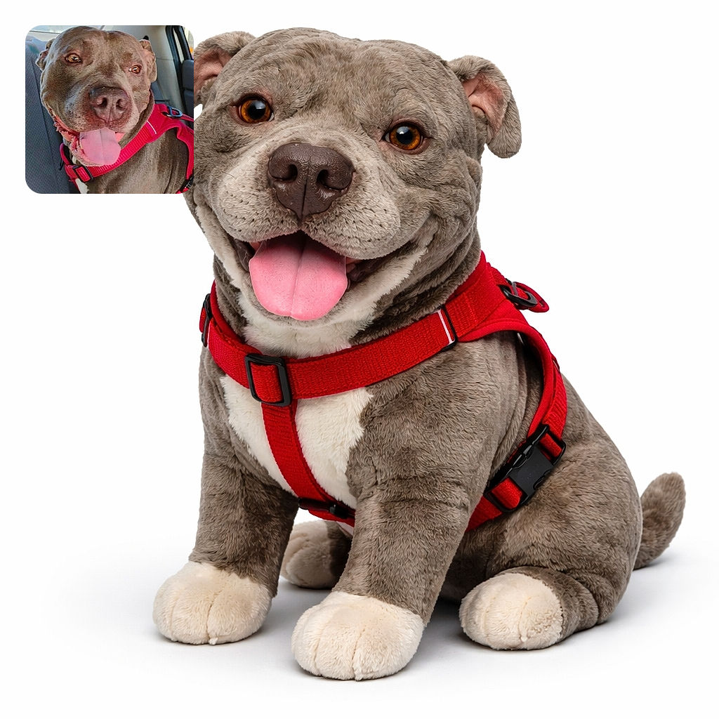 A joyful pitbull monopolizes the backseat — nose and grin filling the frame, tongue lolling out and amber eyes sparkling in sunlight through the car window. Wearing a bright red harness, the dog looks like it just heard the magic word 'park' while the city and upholstery blur politely in the background.
