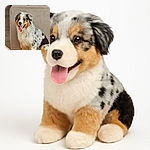 A fluffy Australian Shepherd puppy with a happy, tongue-out expression sits next to a beige couch in a cozy indoor setting. The photo is sharp and well-lit, capturing the dog's adorable spotted fur and joyful mood. The text 'Galaxy S23 Ultra' is clearly overlaid in the bottom left corner.