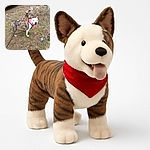 A happy brindle and white dog with a red bandana is standing on dry grass and sticks, tongue out and looking like it just finished a fun play session outdoors.