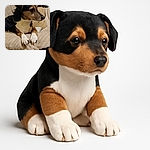 A charming dog lounges comfortably on a plush beige cushion, gazing thoughtfully to the side with its paws neatly placed in front. The cozy indoor setting includes soft textures and a background of household items, creating a warm and homely vibe.