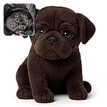 A close-up shot of a curious black puppy lying down, with big shiny eyes looking directly at the camera, capturing an innocent and adorable expression.