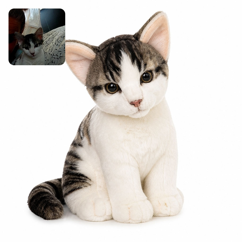 A sleepy-looking white-and-tabby cat poses beside a partially visible human, as if the cat has taken over the bed and is tolerating its paparazzi duties. Soft curtains, a dark wall, and leafy patterned bedding create a cozy bedroom backdrop.