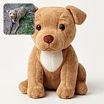 A curious dog with a serious expression lounges on a patch of dirt surrounded by scattered leaves and green plants, as if contemplating the mysteries of the backyard jungle.