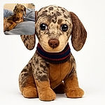 A cozy dachshund with a speckled coat lounges on a soft blue blanket, looking curiously at the camera with big soulful eyes, capturing a candid moment of pure puppy charm.