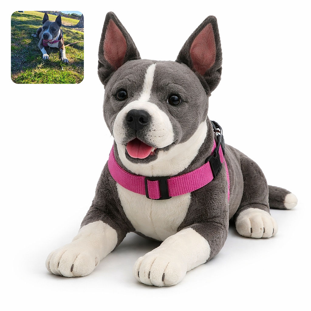 A happy dog with a pink harness lounges comfortably on the grass in a sunny park, soaking up the warmth with a relaxed expression and perky ears, surrounded by trees, a trash can, and a fence in the background.