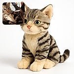 A close-up photo of a relaxed tabby cat lounging comfortably on a soft surface with a cozy indoor background. The cat's expressive eyes and detailed fur patterns are captured clearly, giving a warm and intimate feel.