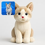 A curious kitten with striking blue eyes and soft fur sits attentively on a plush blue blanket, its ears perked up as if ready to pounce or meow at any moment.
