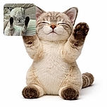 A cozy cat lies on its back with paws stretched up like it's celebrating a tiny victory, surrounded by soft, fluffy blankets and cushions, looking utterly content and relaxed.