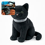 A sleek black cat lounges upside down on a cozy orange blanket, its bright green eyes staring with a mix of curiosity and mischief. The blue wall and wooden floor in the background add a splash of color to this relaxed indoor scene.