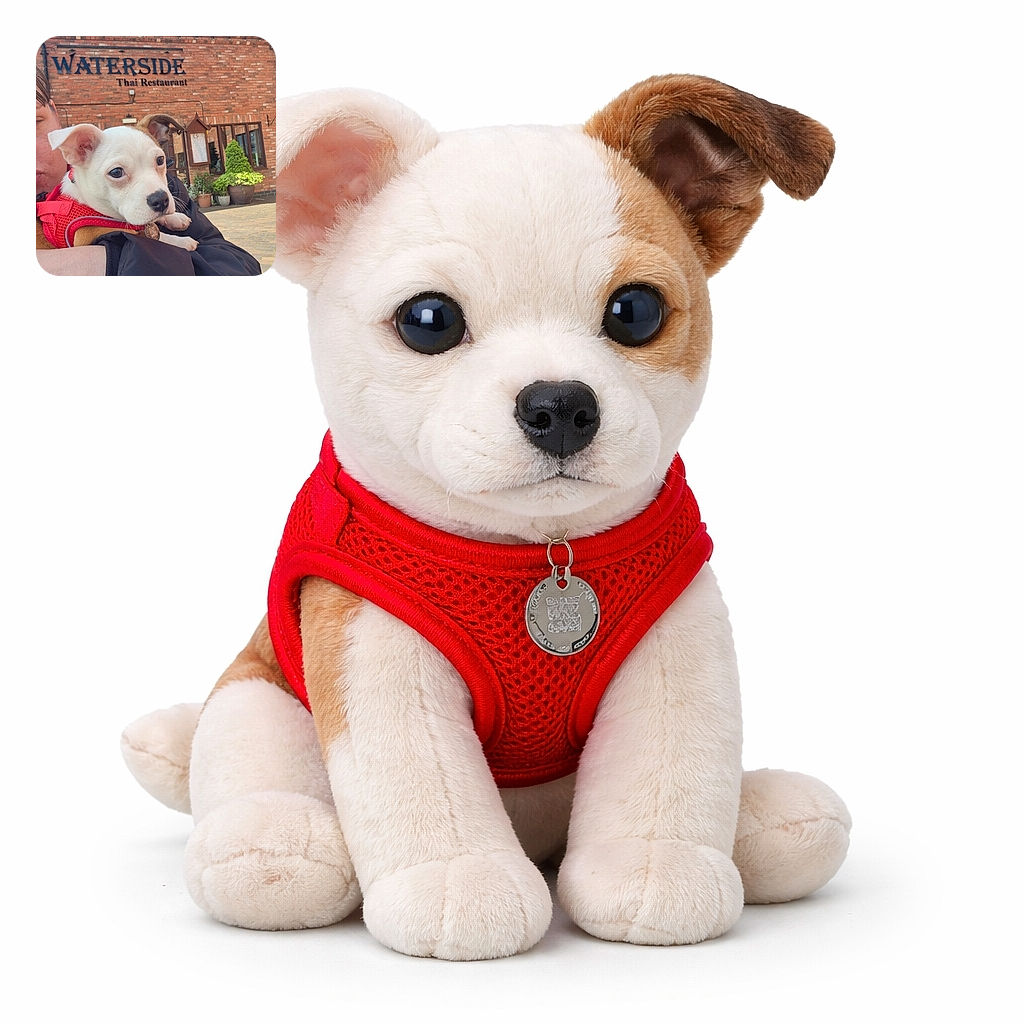 A charming puppy wearing a red harness is being held lovingly by a person outside a brick building with a sign reading 'WATERSIDE Thai Restaurant'. The pup's curious eyes and floppy ears steal the show against a sunny blue sky backdrop and neatly trimmed greenery.