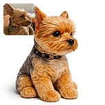 A close-up side profile of a small dog with a shiny black collar, sitting comfortably on a brown blanket with a colorful quilt in the background. The dog's fur is neatly groomed, and its attentive expression suggests it's watching something off-camera.
