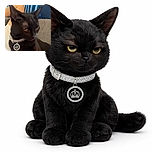 A sleek black cat with a shiny collar and a crown pendant lounges comfortably on a person's chest, giving a slightly unimpressed side-eye look. The background features blue curtains and a gray couch, adding a cozy indoor vibe.