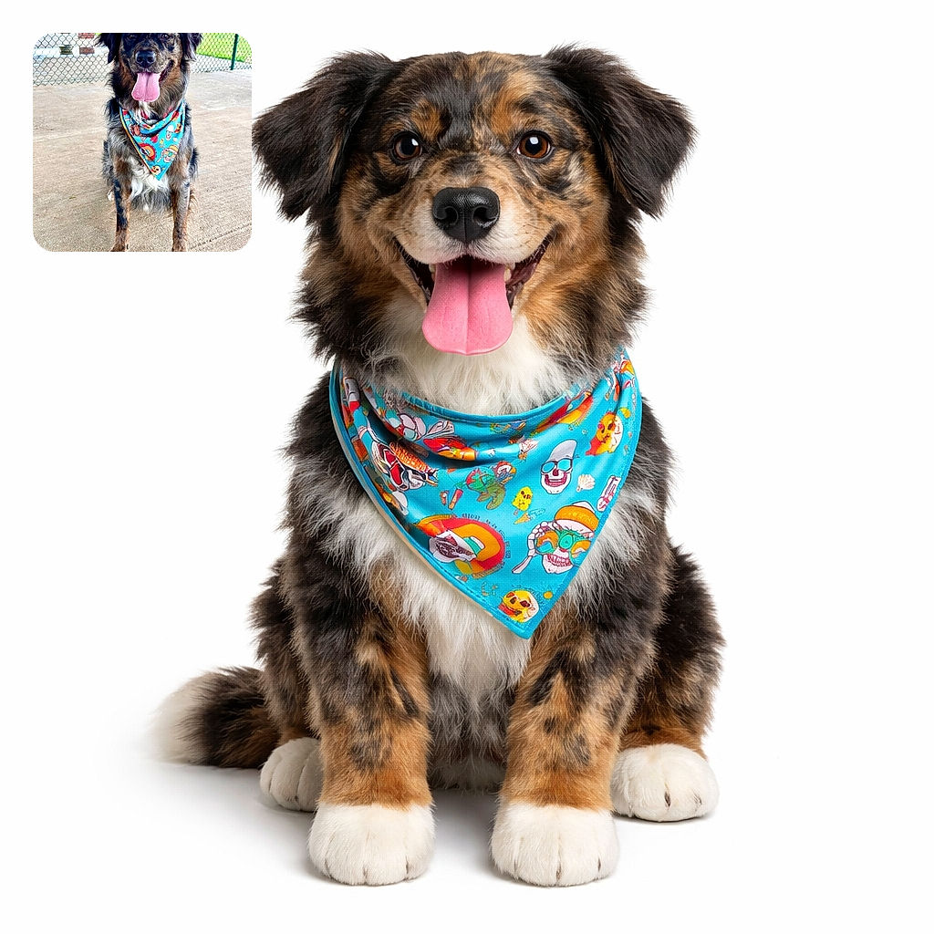 A happy dog with a colorful bandana sits on a concrete floor in front of a chain-link fence, tongue out and looking ready for some fun outdoors.