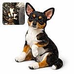 A relaxed small dog with large ears lounges comfortably on a bed with silvery sheets and patterned pillows, looking curiously at the camera with a cozy and charming vibe.