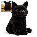 A sleek black cat nestled comfortably on a fluffy yellow blanket, with a colorful striped blanket partially visible, looking curiously to the side in a softly lit, cozy indoor setting.