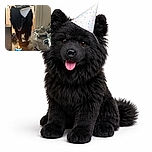 A blurry black dog wearing a party hat approaches a birthday cake topped with a lit number 5 candle and dog bone treats, with some party decorations scattered on the floor in a cozy indoor setting.
