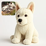 A white dog is lying on the ground outdoors, resting its head on a rock while surrounded by dry leaves and green plants, looking contemplative or a bit sleepy in the sunlight.