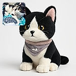 A curious black and white cat lounges on a blue and white striped blanket, gazing intently off-camera with bright yellow eyes. The cat wears a soft harness and rests its paw near a plush Oreo cookie toy, creating a cozy and playful scene inside a car seat.