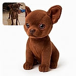 A tiny brown puppy with big, curious eyes stands on a tiled floor, looking slightly startled or intrigued. Behind it, a colorful blanket is casually spread out, and part of a heater or appliance is visible. The lighting is warm but a bit dim, giving the scene a cozy indoor vibe.